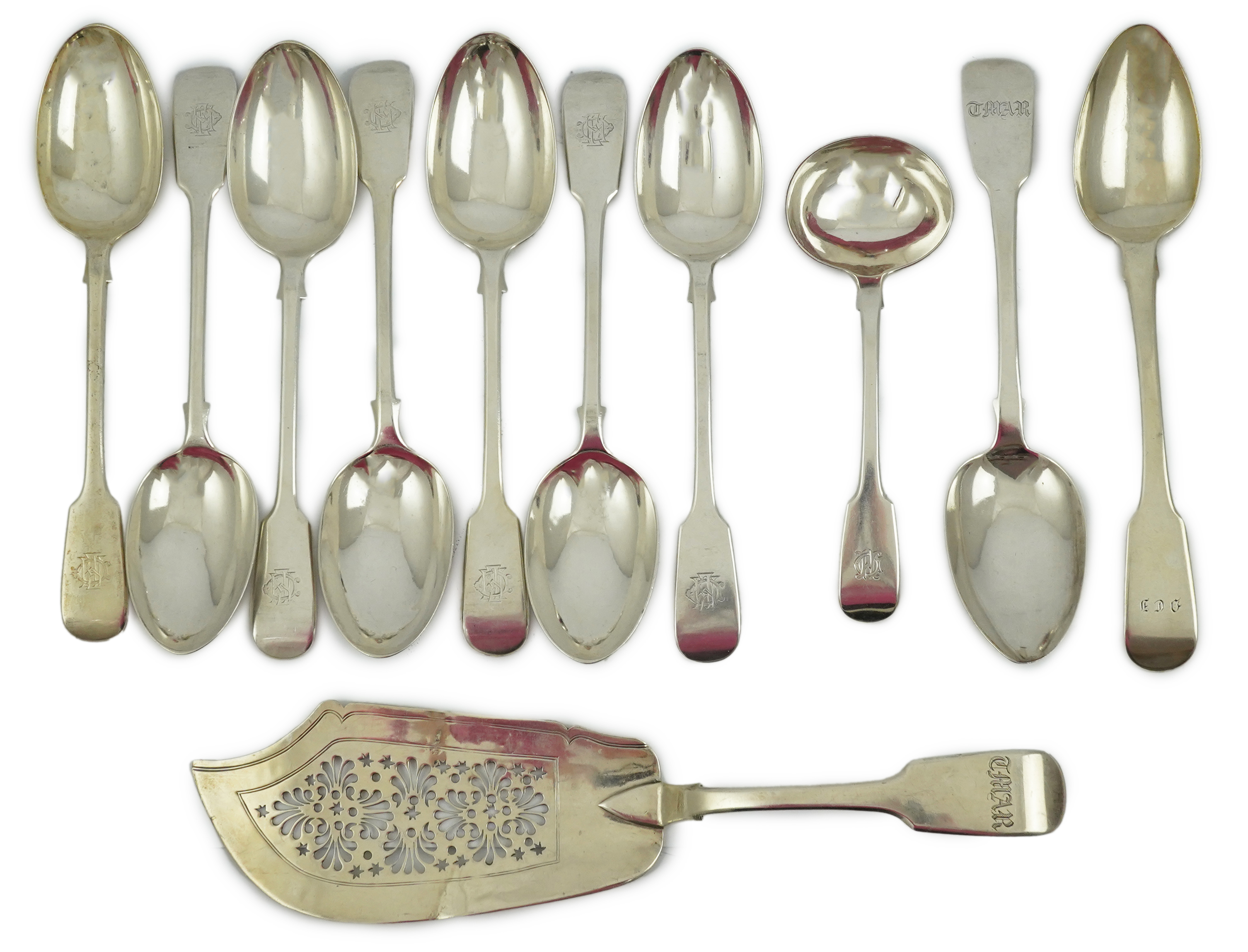 A matched set of seven late Victorian silver table spoons by Goldsmiths & Silversmiths Co Ltd (5) and Francis Higgins (2), London, 1894, together with a similar silver sauce ladle, two earlier silver table spoons and a W